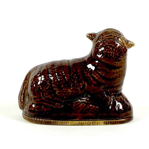 43 - A rare Newcastle pottery figure, 17th / 18th century, modelled as a recumbent sheep, all over treacl... 