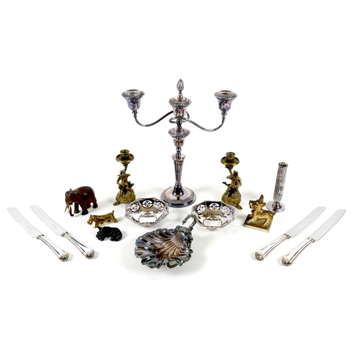 77 - A group of mixed metal collectables, comprising a pair of cast brass figural candlesticks, each mode... 