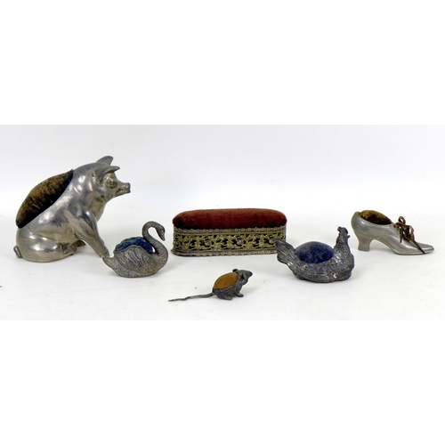 78 - Five novelty white metal pin cushions, comprising a pig, 10.5cm high, a swan, 6cm high, a hen, 5.5cm... 