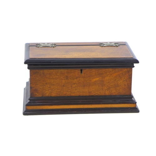 94 - An Edwardian oak casket box, with ebonised edges, lift lid opening to reveal a satinwood lined inter... 