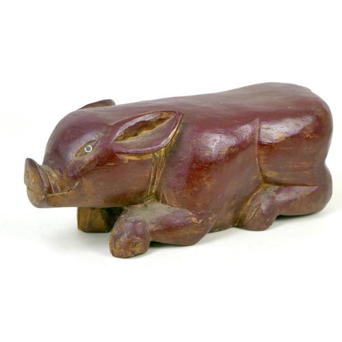 95 - A 20th century carved wooden shabby chic pig, painted maroon, 46 by 19 by 18cm high.