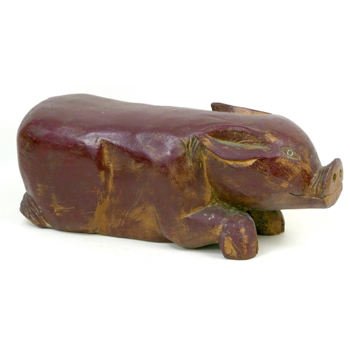 95 - A 20th century carved wooden shabby chic pig, painted maroon, 46 by 19 by 18cm high.