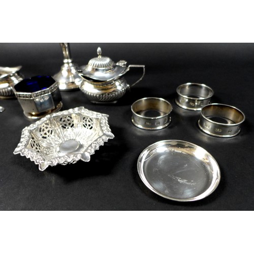 23 - A collection of silver items, comprising a pair of George III silver sugar tongs, shell, fiddle and ... 