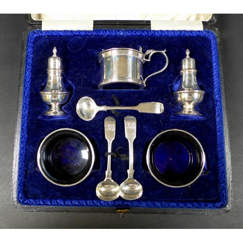 26 - A group of silver items, including a cruet set, in associated case, christening set, cased, milk jug... 
