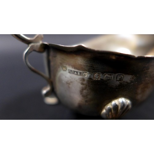 7 - A group of three silver items, comprising a cut glass silver topped sugar sifter, 18cm high, a milk ... 
