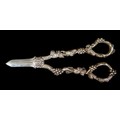 A pair of Edward VII silver grape scissors, with ornate cast handles decorated with fruiting vines, ... 