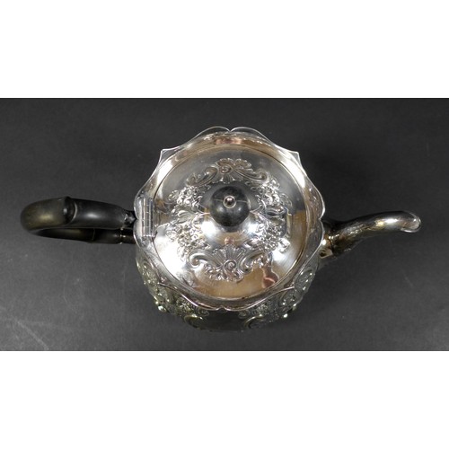 41 - A Victorian silver teapot, repousse decorated with flowers and C scrolls in rococo style, ebonised h... 