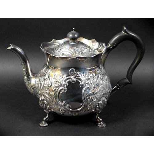 41 - A Victorian silver teapot, repousse decorated with flowers and C scrolls in rococo style, ebonised h... 