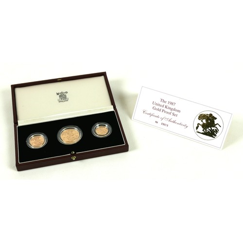 A Queen Elizabeth II Royal Mint gold proof three coin set, 'The 1987 United Kingdom Gold Proof Collection', no 01263, comprising two pounds, sovereign, and half-sovereign, limited edition, with certificate No 09615, in red leather gold embossed presentation box.