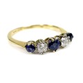 An 18ct gold, diamond and sapphire ring, formed of three graduated deep cornflower blue sapphires in... 