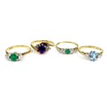 A group of four 9ct gold rings, comprising an amethyst and diamond ring, size O, two green stone and... 