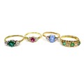 A group of four 9ct gold rings, comprising a pink sapphire and diamond ring, size L, two green stone... 