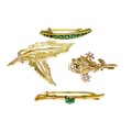 A group of four 9ct gold brooches, one Victorian of curved lozenge form set with graduating green st... 
