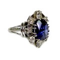 A sapphire and diamond dress ring, the oval geometric cut royal blue sapphire of approximately 12 by... 