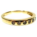 A 9ct gold and cognac diamond seven stone ring, the brilliant cut stones graduating from 2.2mm to 1.... 