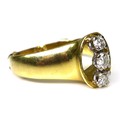 An 18ct gold and three stone diamond ring, of openwork modernist design, the three stones brilliant ... 