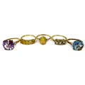 A group of 9ct gold rings by The Genuine Gemstone Company, including two dress rings, all size N/O, ... 