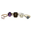 A group of five dress rings, comprising a 9ct gold ring set with an emerald cut smoky quartz, 16 by ... 