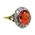 An 18ct yellow gold dress ring, set with an oval cut orange coloured stone, approximately 10 by 8 by... 