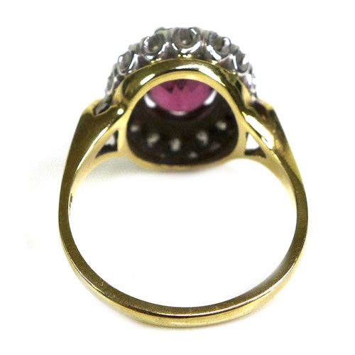 282 - An 18ct yellow gold dress ring, set with an oval cut red/purple coloured stone, approximately 10 by ... 