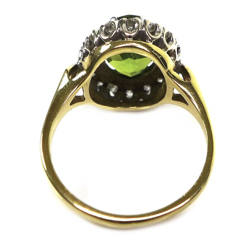 283 - An 18ct yellow gold dress ring, set with an oval cut green coloured stone, likely peridot, approxima... 