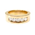 An 18ct gold and five stone diamond ring, the wide heavy band, 6mm wide, inset with brilliant cut st... 
