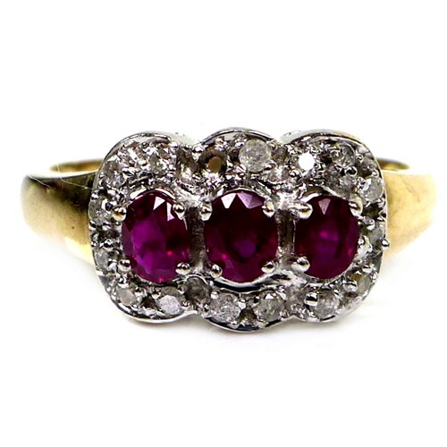 279 - An 18ct gold and ruby three stone ring, each stone of approximately 4 by 3.5mm, with diamond chips t... 