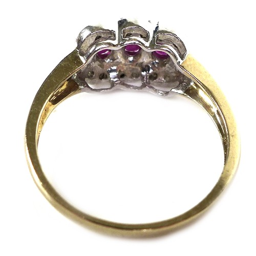 279 - An 18ct gold and ruby three stone ring, each stone of approximately 4 by 3.5mm, with diamond chips t... 