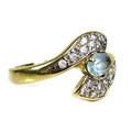 An 18ct gold and aquamarine ring, the oval cut stone of pale blue colour, approximately 6 by 4 by 3m... 