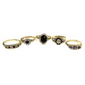 A group of five 9ct gold rings, comprising a 9ct gold and dark stone ring, the stone oval cut and of... 