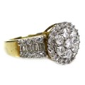 A 9ct yellow gold and diamond ring, of target form with wide tapering shoulders, set centrally with ... 