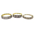 A group of three 18ct yellow gold and diamond rings, comprising a three stone ring, the round cut st... 