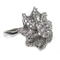An 18ct white gold and diamond flowerhead dress ring, set centrally with a flowerhead of seven round... 