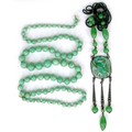 Two jade necklaces, the first a string of graduating round beads, largest bead approximately 1.4cm d... 