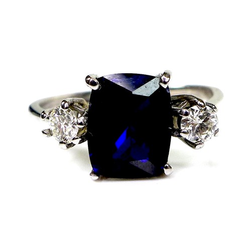 298 - An 18ct white gold, sapphire and diamond ring, the royal blue sapphire measuring 9.92 by 8.07mm, fla... 