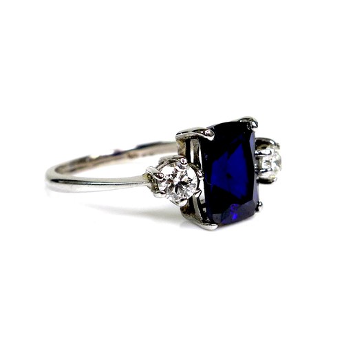 298 - An 18ct white gold, sapphire and diamond ring, the royal blue sapphire measuring 9.92 by 8.07mm, fla... 