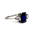 An 18ct white gold, sapphire and diamond ring, the royal blue sapphire measuring 9.92 by 8.07mm, fla... 