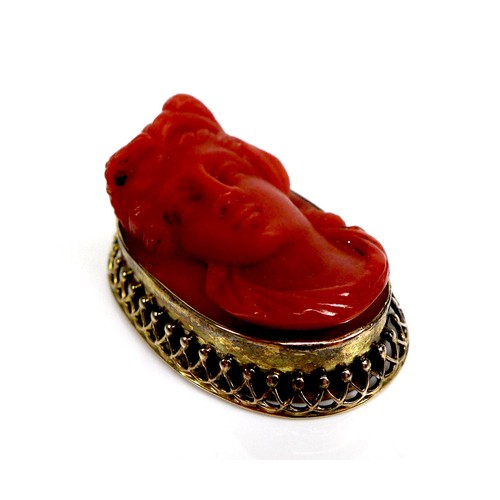 256 - A carved coral relief pendant depicting the bust of a lady, set into a yellow metal rope and bead se... 