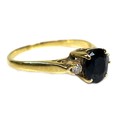 A gold, sapphire and diamond ring, the central oval cut sapphire of deep colour and approximately 6.... 
