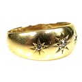 An 18ct gold gypsy ring, set with two diamonds (missing one) in star engraved surrounds, JH, Birming... 