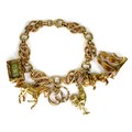 A 9ct gold fancy link charm bracelet, with six 9ct gold charms, each hallmarked, chain approximately... 
