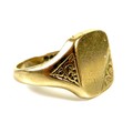 A 9ct gold gentleman's signet ring, the blank cartouche with foliate engraved corner and shoulders, ... 