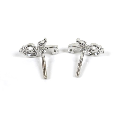 276A - A pair of 18K white gold and diamond earrings, formed as flowers, set with a marquise cut stone, 4.0... 