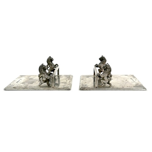 17A - A pair of Scottish Victorian silver knife rests, each formed as a cross bar supported by a pair of r... 