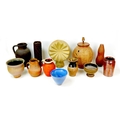 A collection of stoneware vessels and other decorative pieces, including a circular form ornament, 3... 