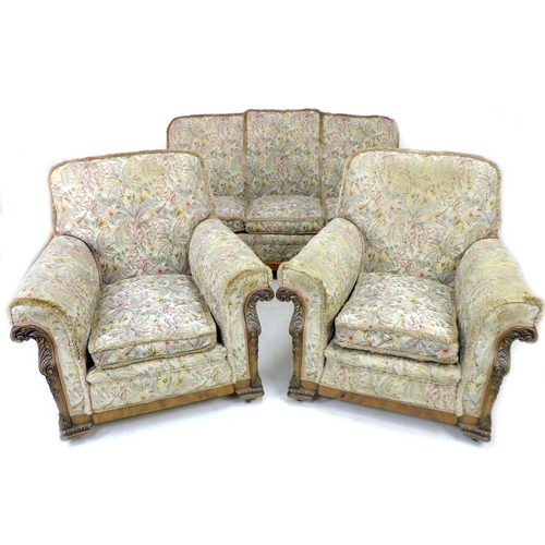 226 - An early 20th century three-piece suite, upholstered in floral fabric, with foliate carved decoratio... 