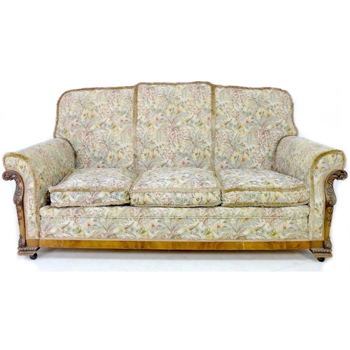 226 - An early 20th century three-piece suite, upholstered in floral fabric, with foliate carved decoratio... 