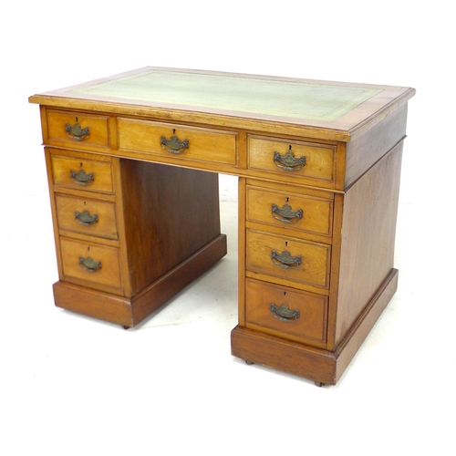 238 - An Edwardian walnut twin pedestal desk, with green leather surface, nine drawers with brass handles,... 