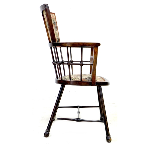 253 - An Arts & Crafts bobbin armchair, with floral upholstered seat and back, raised on splayed legs with... 