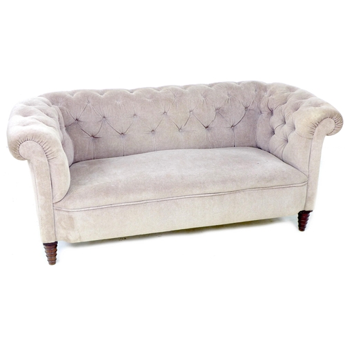 255 - A Chesterfield two seater settee, early 20th century, upholstered in button back beige fabric, raise... 